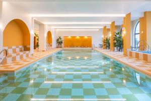 a pool in a hotel with a tile floor at SeaSpace in Newquay