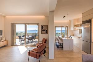 a kitchen and living room with a view of a table at Yialos Neapoli in Neapoli Voion