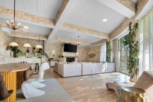 a living room with white furniture and a brick wall at Castle Transylvania in Alba Iulia