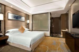 Postel nebo postele na pokoji v ubytování Ramada Foshan Hotel