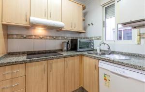 a kitchen with a sink and a microwave at 3 Bedroom Cozy Apartment In Torrevieja in Torrevieja