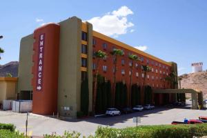 a hotel building with cars parked in a parking lot at Railroad Pass Hotel and Casino Ramada by Wyndham in Boulder City