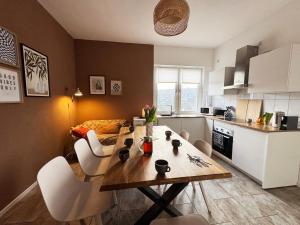 a kitchen with a table and chairs in a kitchen at Big apartment with Parking, 30 min to Düsseldorf in Duisburg +21 photos