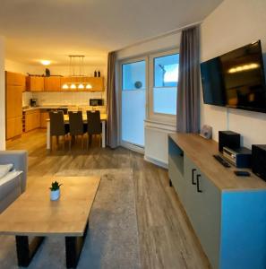 a living room with a kitchen and a dining room at Fewo 4 in Willingen +6 photos