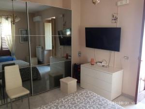 a living room with a tv and a bedroom at Bed and breakfast Il Girasole in Lauro
