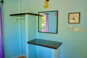 a bathroom with a mirror and a blue wall at Baan Sarika Phusuan in Nakhon Nayok +104 photos