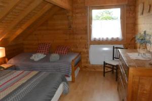 a bedroom with a bed in a wooden cabin at Chalet sous Le Théâtre in Bussang
