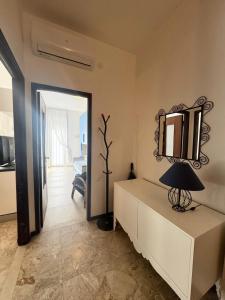 a room with a mirror and a table with a lamp at Casa Dante in Finale Ligure
