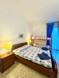 a bedroom with a bed and a night stand with a lamp at Casa Dante in Finale Ligure