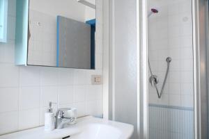 a white bathroom with a sink and a shower at Trilocale a 150 mt dal mare di Marcelli - M244 in Marcelli