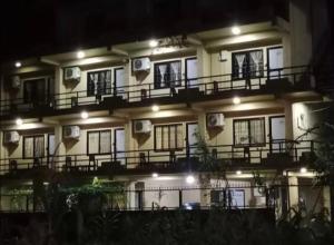 a building with balconies on the side of it at night at Sauraha Inn in Sauraha