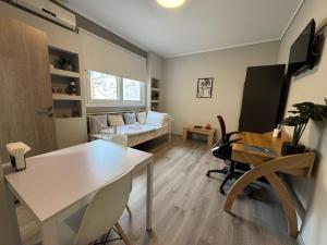 a living room with a table and a couch at Work from home Project in Thessaloniki