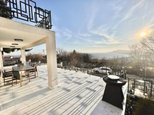 a patio with a table and chairs on top of it at Aquamarine House in Balchik