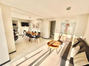a living room with a couch and a table at Aquamarine House in Balchik