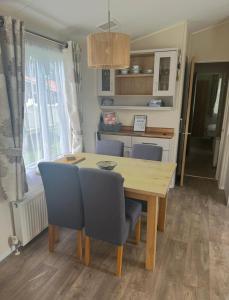 a dining room with a wooden table and chairs at The Meadows in Tattershall