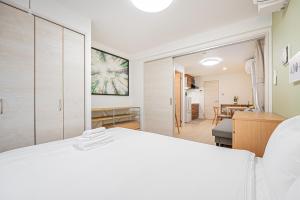 a bedroom with a white bed and a dining room at Float Inn Shin-Okachimachi in Tokyo