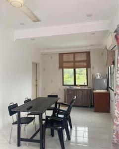 a dining room table and chairs in a kitchen at EasyStay Apartment Langkawi in Kuah