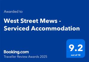 a blue sign with the words west street news serviced accommodation at West Street Mews - Serviced Accommodation in Exeter