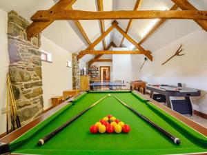 a pool table with balls on it in a room at Ystumgwern Luxury Barn Conversions in Dyffryn