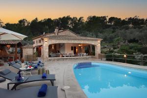 a villa with a swimming pool and a house at Villa Alordes in Pollença