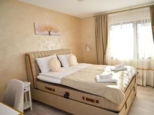 a bedroom with a large bed with a window at КЪЩА ЗА ГОСТИ ГРОШЪ in Dobrinishte +53 photos