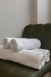 a pile of towels sitting on a green couch at PREMIUM B&B Nova Gorica, Self Check-In with code access in Nova Gorica +41 photos