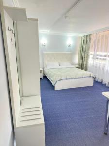 a bedroom with a bed and a mirror at Байтерек рядом Министерство in Astana +8 photos