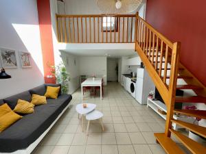 a living room with a couch and a staircase at BnGo I Maison Terracotta I Jardin, Garage, 3 chambres, 9 personnes in Villeurbanne +37 photos