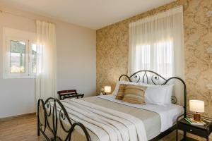 a bedroom with a large bed and a window at Casa Loggia in Lixouri
