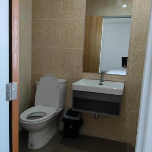 a bathroom with a toilet and a sink and a mirror at The first house 11126 in Ban Phlu Yai +7 photos