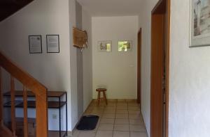 a hallway with a staircase and a stair case at Ferienwohnung Mossauer Hoehe in Mossautal +22 photos