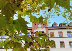 a building with a clock tower on top of it at ODELYA - Stadthotel im Park in Basel
