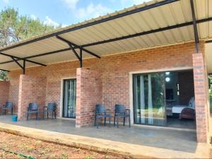 a patio with awning with chairs and a table at Kataluma in Pretoria