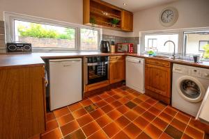 a kitchen with a washer and dryer at Frodo's Folly in Port Talbot
