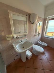 a bathroom with a sink and a toilet at Tropea Boutique Hotel in Tropea