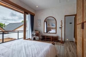 a bedroom with a large bed and a mirror at Avyara Villa - Brand NEW, Luxury Tropical with Private Pool in Dalung +35 photos