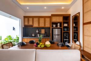 a kitchen with a table with a bowl of fruit on it at Avyara Villa - Brand NEW, Luxury Tropical with Private Pool in Dalung