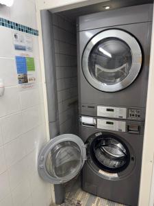 a washing machine in a bathroom with a washer at Studio au coeur de Valence 45 in Valence +3 photos