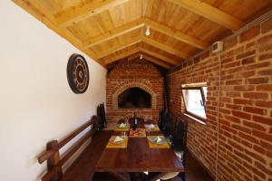 a dining room with a table and a brick wall at Villa Dora with heated pool & fitness in Gradina