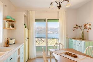 a kitchen with a table with a view of the ocean at Casa Loggia in Lixouri