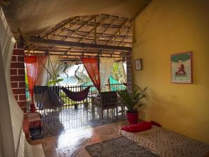 an inside view of a room with a hammock at Secret Garden Agonda Beach Resort in Agonda