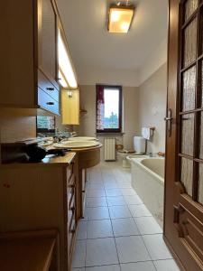 a bathroom with a sink and a tub and a toilet at Kibilù - Il Nido di Laveno in Varese