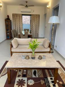 a living room with a couch and a table at A perfect place to be in nature in Kolkata