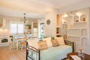 a living room with a couch and a kitchen at Casa Loggia in Lixouri +30 photos