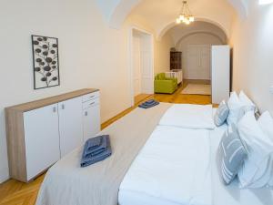 Dos camas blancas en una habitación con una habitación con en Luxury Vincents Apartments Kosice, en Košice