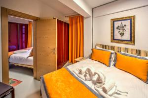 a bedroom with orange curtains and a bed in a room at Vavien Hotel in Istanbul