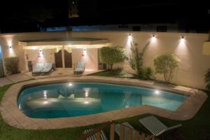 a swimming pool in a yard at night at Corrientes Plaza Hotel in Corrientes +30 photos