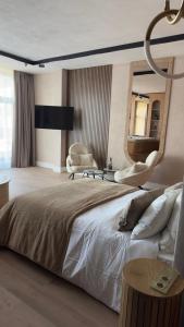 a bedroom with a large bed and a mirror at Alpine Oasis - Silver Mountain in Poiana Brasov