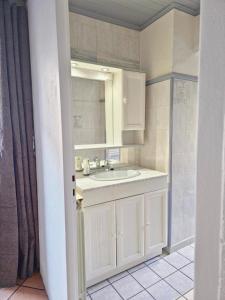 a bathroom with a sink and a mirror at Logis Montagnard in Modane +10 photos