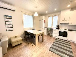 a kitchen with a table and a dining room at Apartment Sorsakuja in Pyhäjoki